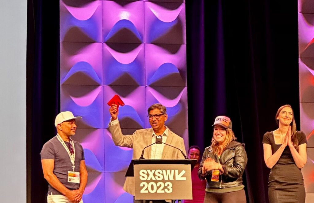 The Included.ai team accepts their award at the 2023 SXSW Conference