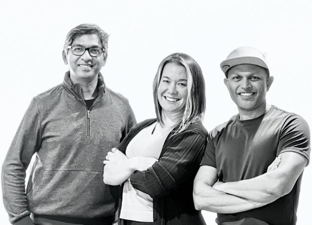 Three people standing next to each other with their arms crossed.